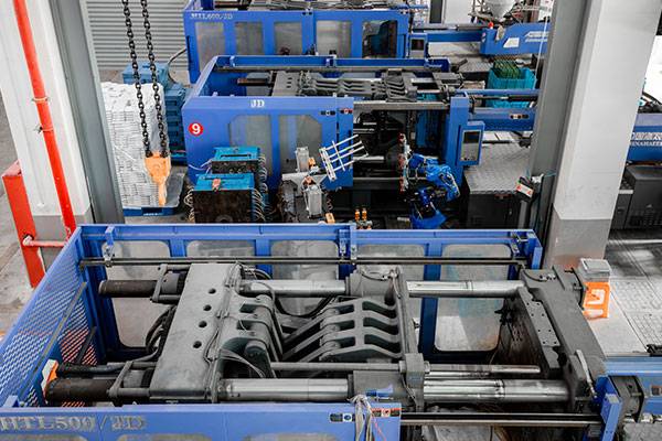 A row of automatic injection molding machines